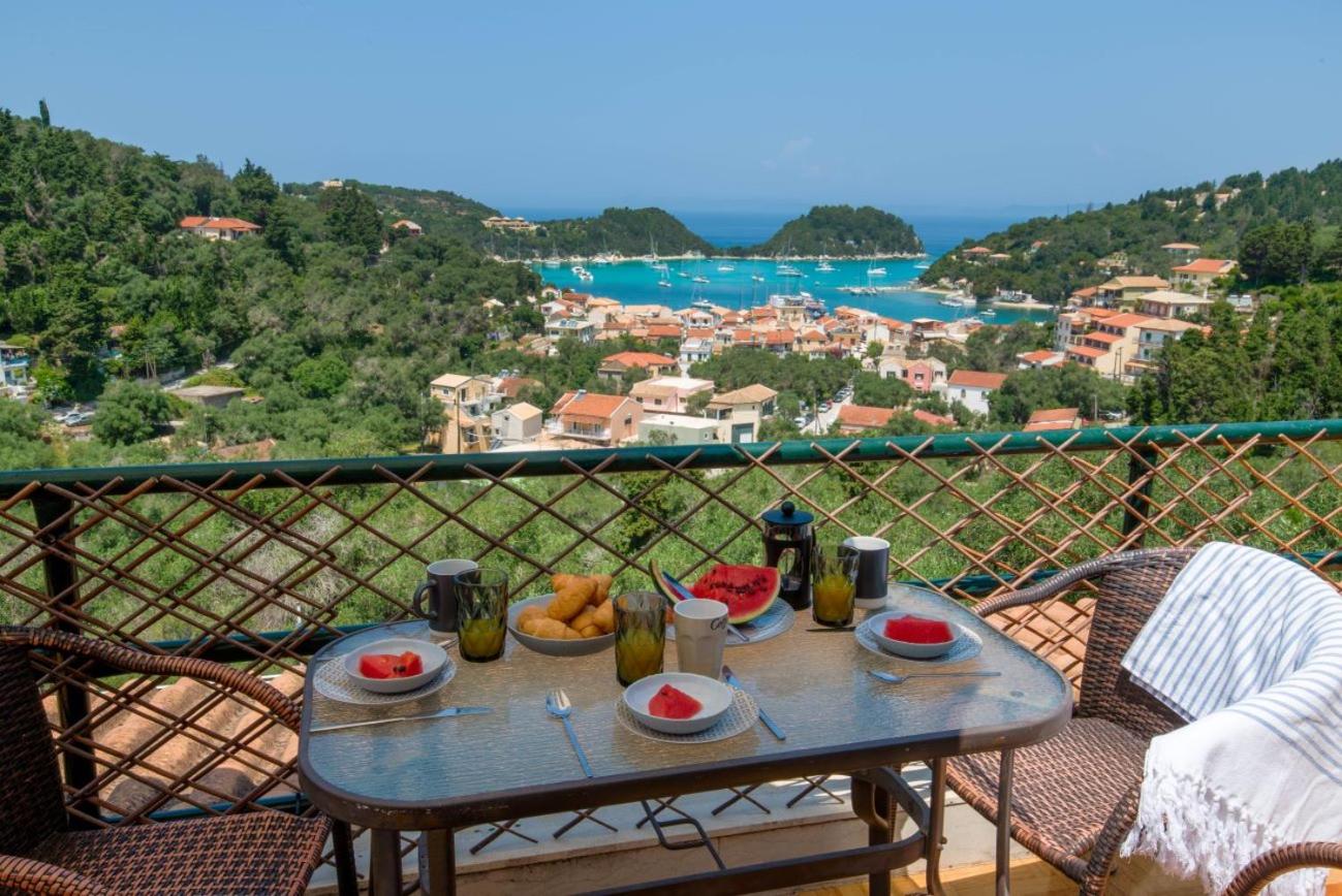 Breakfast with croissants and coffee on a balcony overlooking Lakka bay
